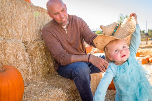 Adorable Young Family Enjoys a Day at the Pumpkin Patch.