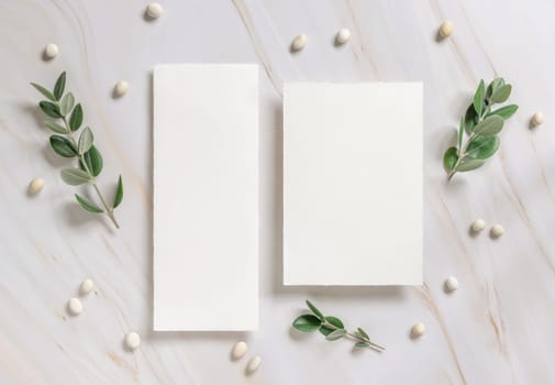 Vertical cards on a marble table decorated with eucalyptus branches and white stones top view, Wedding Mockup. Romantic flat lay with blank menu card. Minimal composition. Close to nature
