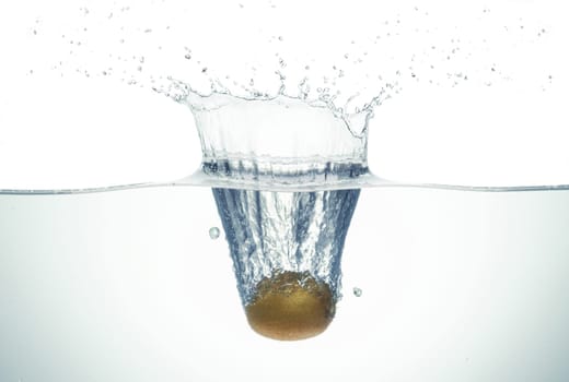 Kiwi splashing in water. Side view on white background.