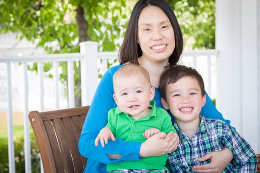 Outdoor Portrait of A Chinese Mother with Her Two Mixed Race Chinese and Caucasian Young Boys