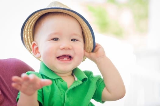Portrait of A Happy Mixed Race Chinese and Caucasian Baby Boy Wearing His Hat