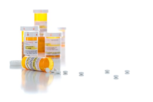 Non-Proprietary Medicine Prescription Bottles and Spilled Pills Isolated on a White Background.