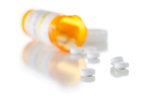 Non-Proprietary Medicine Prescription Bottle and Spilled Pills Isolated on a White Background.