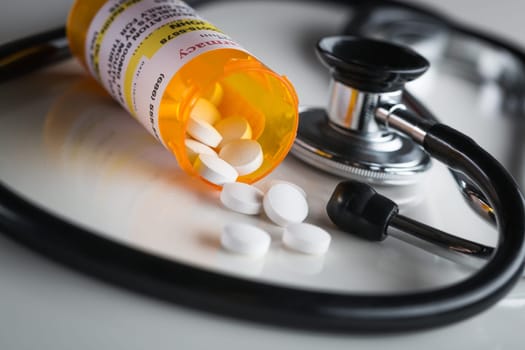 Non-Proprietary Medicine Prescription Bottles and Spilled Pills Abstract with Stethoscope.
