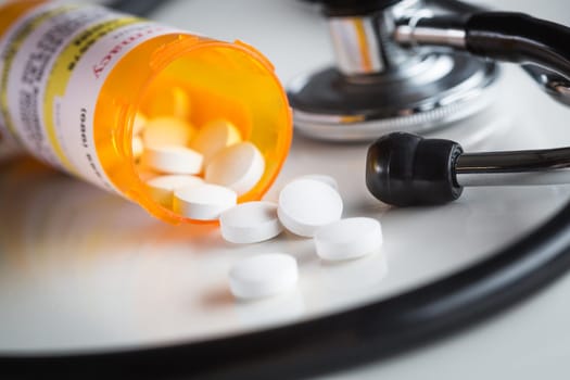 Non-Proprietary Medicine Prescription Bottles and Spilled Pills Abstract with Stethoscope.