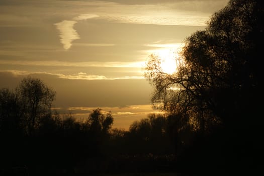 Setting sun on the outskirts of Berlin. The sky seems to burn. Romantic evening sky.