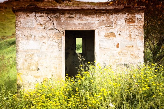 Littlle abandoned house stone in countryside in Sardinia