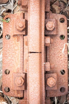 Bolts rusted tracks. Particular of a rail tie with track and rusted bolts