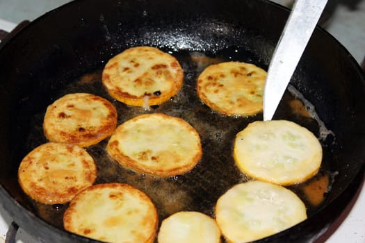 cooking tasty dish from fried squash on the pan