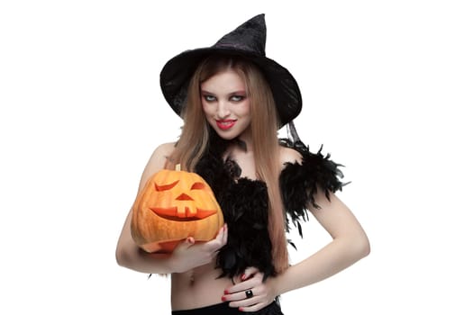 Girl in witch costume with Halloween pumpkin isolated on white background
