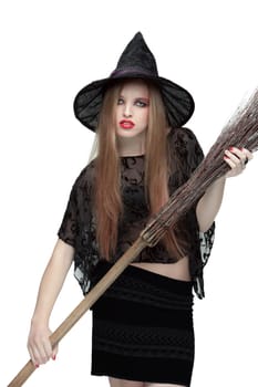 Young girl in black witch costume with a broom isolated on white background. Halloween