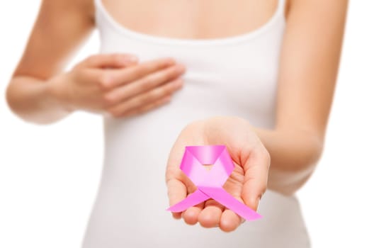 Woman holding a pink cancer awareness ribbon in her hands