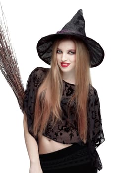 Girl in black witch costume with a broom isolated on white background. Halloween