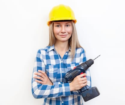 Young woman doing the DIY work and wearing protective helmet