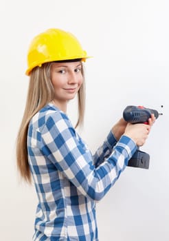 Young woman doing the DIY work and wearing protective helmet