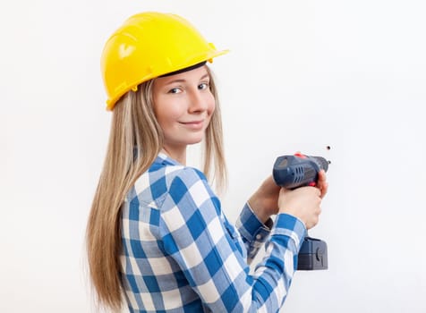 Young woman doing the DIY work and wearing protective helmet