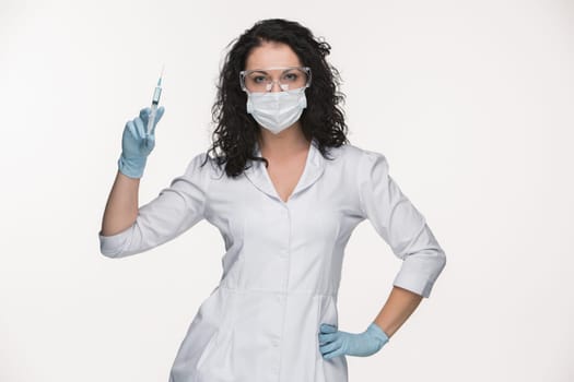 Portrait of lady surgeon in glasses showing syringe isolated on white background
