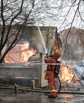 Firefighter Fighting Fire in residential house in Sweden.