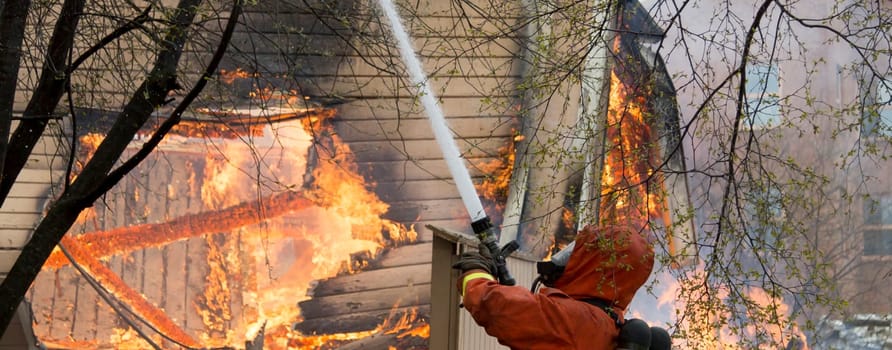 Firefighter Fighting Fire in house with water