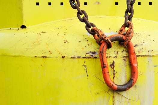 Red carabiner on yellow bottle
