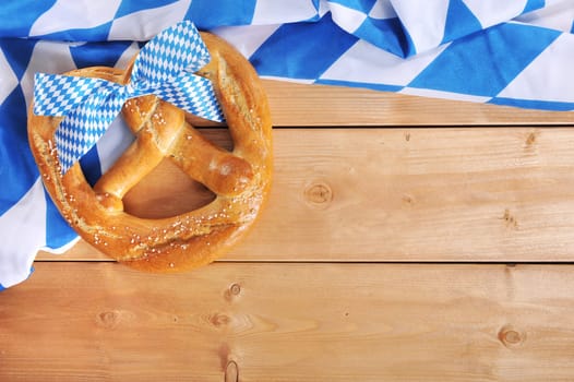 original Bavarian giant folk festival breze with Bavarian flag on wooden boards