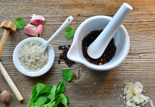 Pepper salt garlic nutmeg on a wooden board