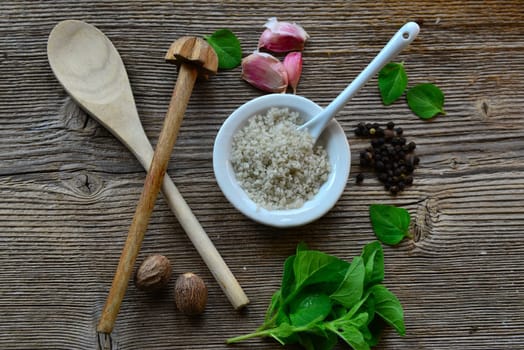 Pepper salt garlic nutmeg on a wooden board