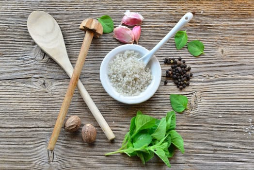 Pepper salt garlic nutmeg on a wooden board