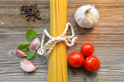 Pasta Tomatoes Parmesan on wood background
