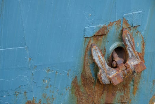 A rusty anchor on a boat to the seaport
