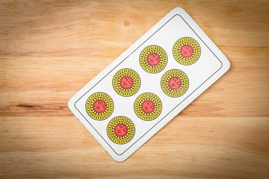 Seven, settebello italian card on a wood background