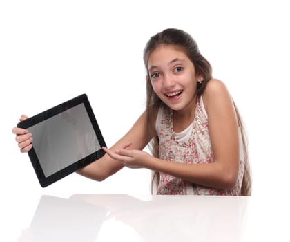 Beautiful pre-teen girl with a tablet computer. Isolated. Clipping path for the screen