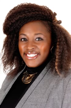 A lovely portrait picture of a African American woman, smiling in a grey.jacket, isolated for white background..