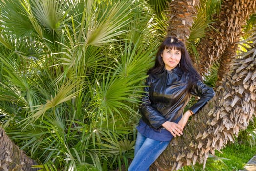 portrait of an ukrainian girl visiting Rome posing near a palm tree