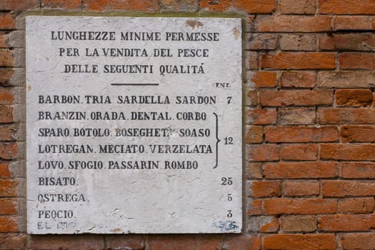 A close up of an historical sign at ancient fish market place, Venice, Italy