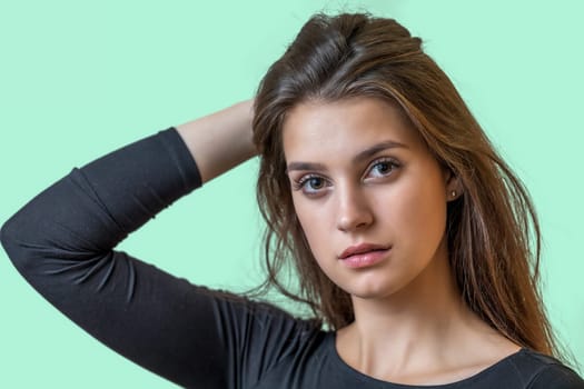 Portrait of beautiful girl on the green background. Horizontally.