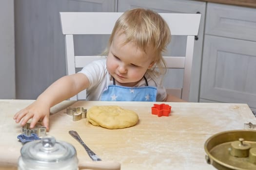 Little boy helps to bake Christmas cookies. Little helper. Horizontally.
