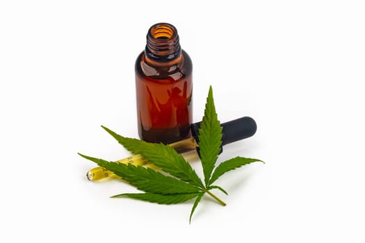 Cannabis oil hemp oil with fresh cannabis leaf on bright background