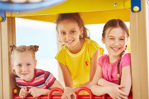 Friendly girls looking at camera on playground