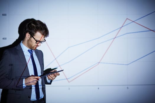 Handsome businessman with touchpad preparing presentation