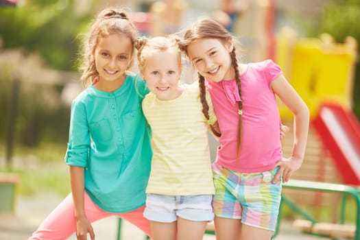 Active friends in casualwear looking at camera outdoors