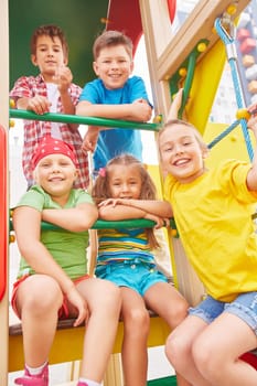 Group of friendly kids looking at camera on playground