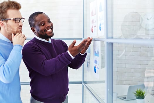 Confident managers comparing financial reports in office