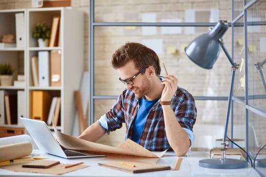 Young businessman learning draft at workplace