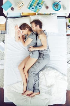 Young couple sleeping in bed