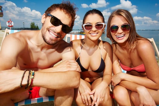 Happy friends relaxing on the beach