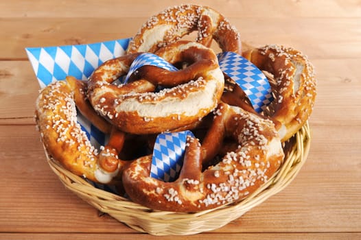 original Bavarian lye pretzels with salt in a basket on wooden boards