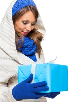 Young attractive woman with blue wool hat holds a gift for birthday Christmas in hand isolated on white background