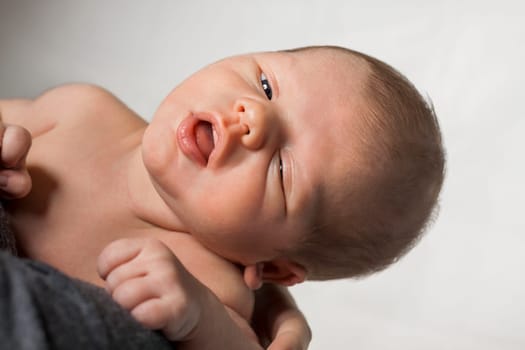 Newborn baby on mother's arm portrait me face as close-up