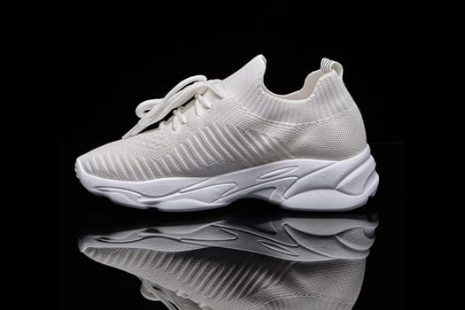 sneakers women's white summer breathable sneakers children's school uniform slip-ons for girls textile on black background. High quality photo